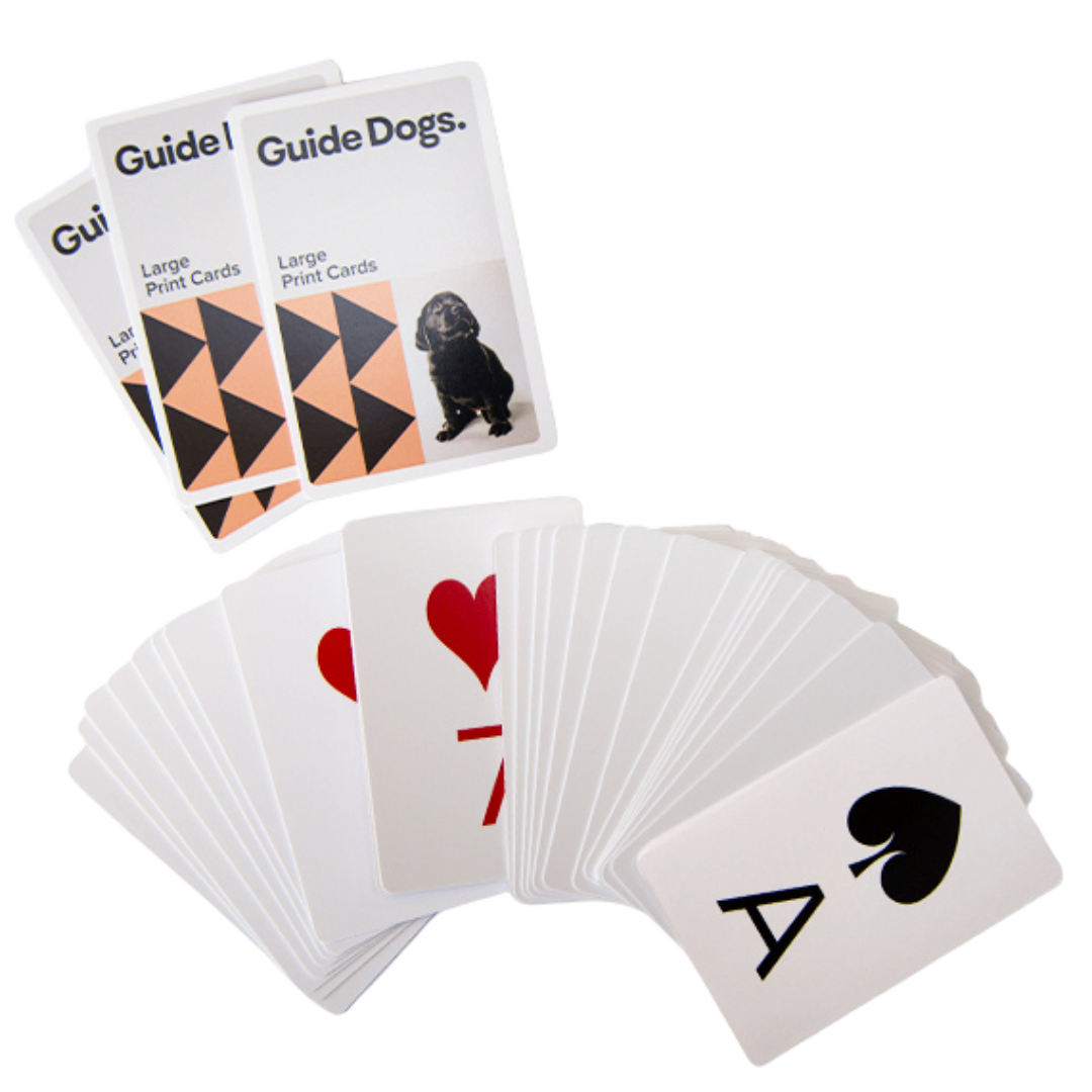 Image of a deck of playing cards in large print with 3 cards with Guide Dogs logo above.