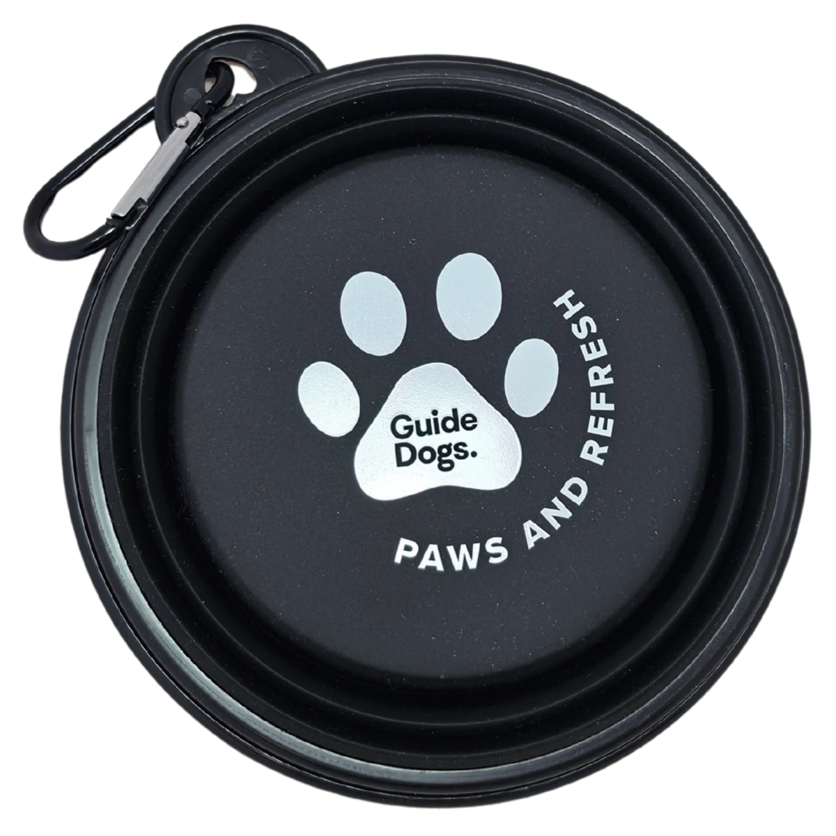 Image of a black collapsible dog water bowl with a carabiner clip, shown closed. The inside features a white paw print logo with the text 'Guide Dogs.