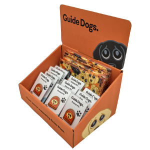 Image of Starter Fundraising Box: orange display with "Guide Dogs" text, holds dog-themed fundraising items with faces and paw prints.