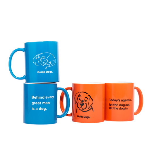 Image of four ceramic mugs for dog lovers, two blue and two orange, featuring fun designs and messages on white.
