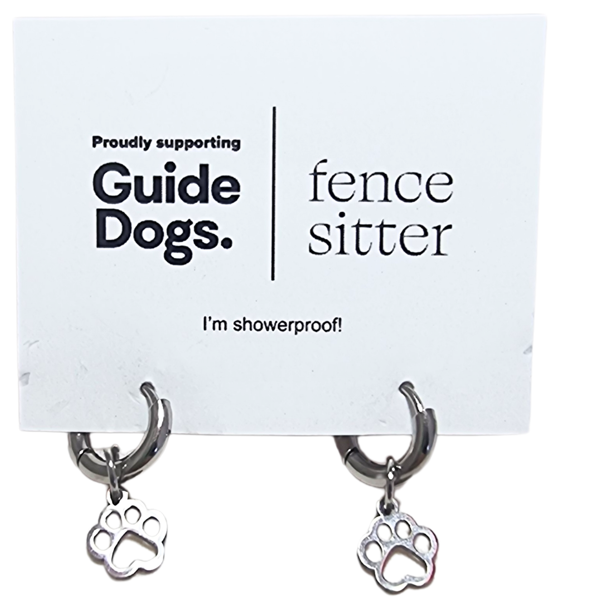 Image of a pair of earrings with paw charm on a card supporting Guide Dogs.