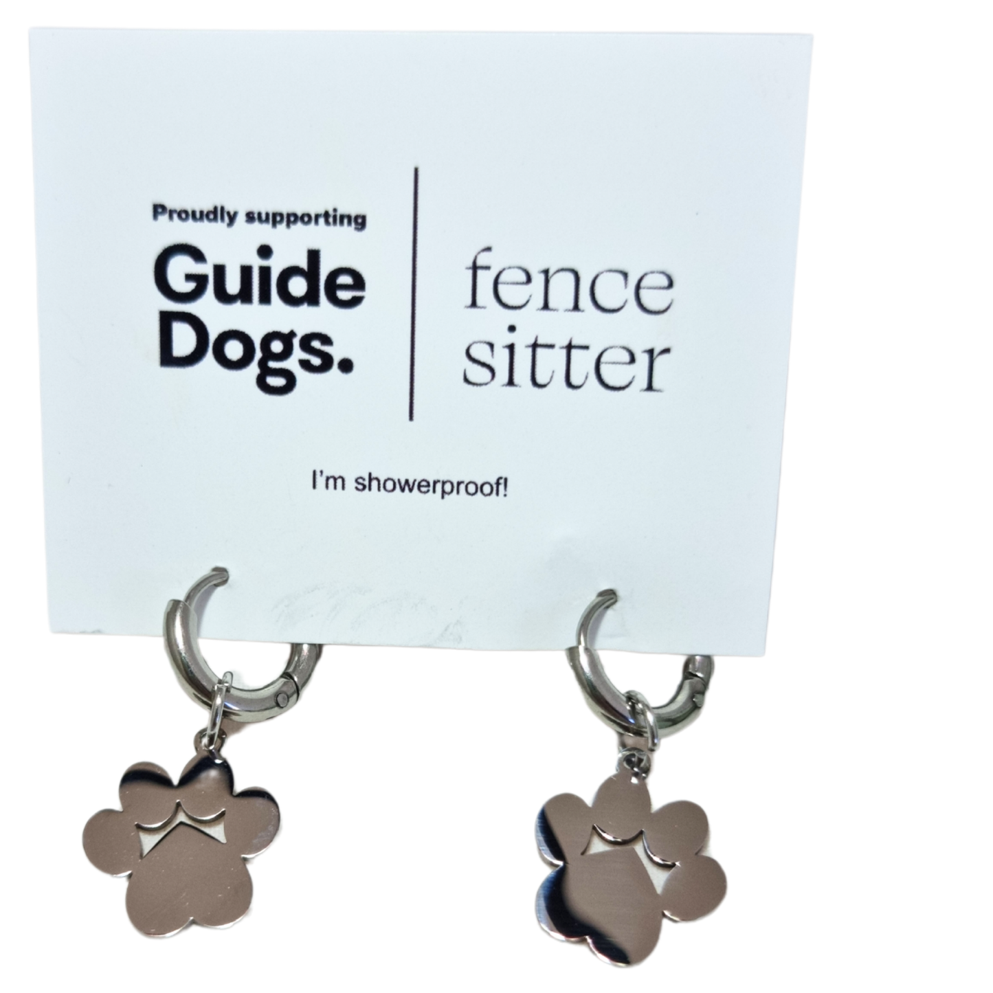 Image of a pair of earrings with paw design and 'Proudly supporting Guide Dogs' card on a white background