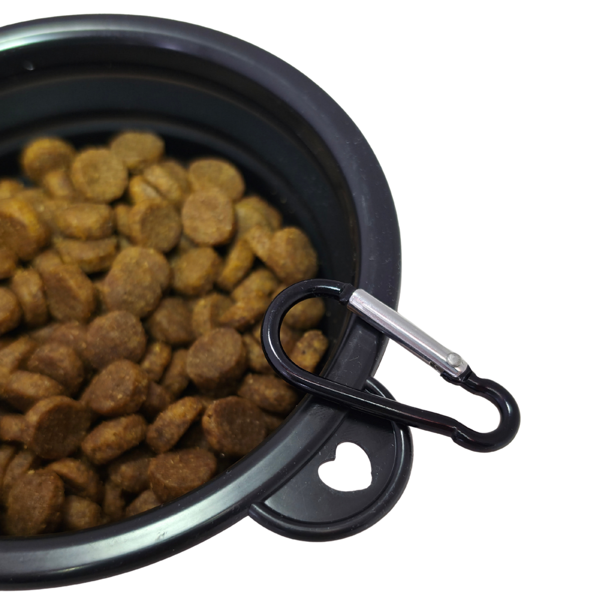 Image of a close-up of a black collapsible pet bowl filled with brown kibble, with a black carabiner clipped to the rim against a white background.