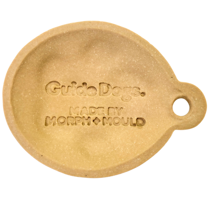 Image of Beige, round ceramic dog Christmas ornament by Morph + Mould, right-side hole, features Guide Dogs design.