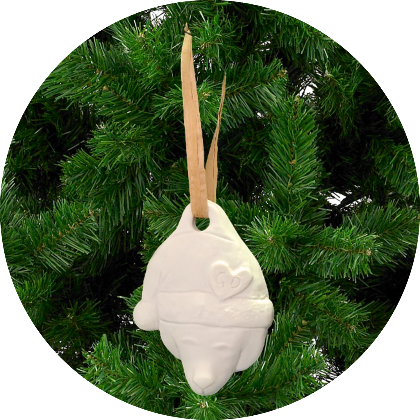 Image of Christmas Ornaments: White bear with heart hangs from tan ribbon on green artificial tree.