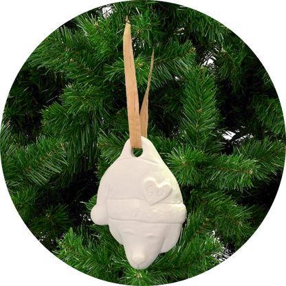Image of Christmas Ornaments: White bear with heart hangs from tan ribbon on green artificial tree.