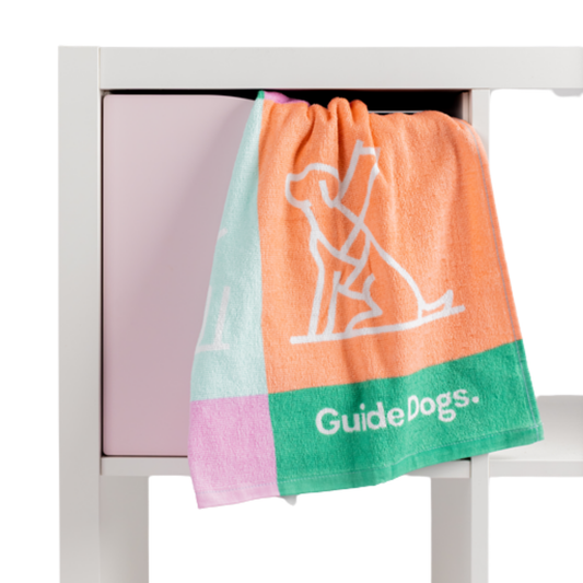 Image of A Tea Towel- Puppy Icons (2 pack) hangs over a white and pink cabinet.
