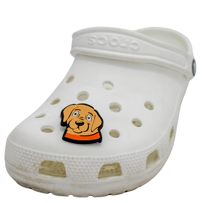 Image of a white clog shoe with a beige puppy face with orange collar Shoe Charm on the front.