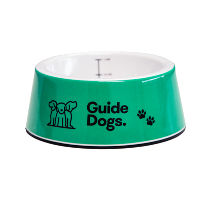 Image of a green pet bowl with 'Guide Dogs' text and logo on a white background