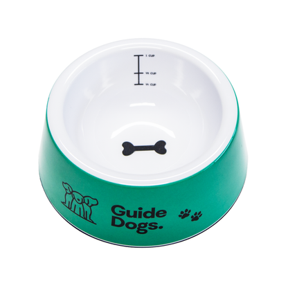 Image of a green and white dog bowl with 'Guide Dogs' text and bone symbol on a white background