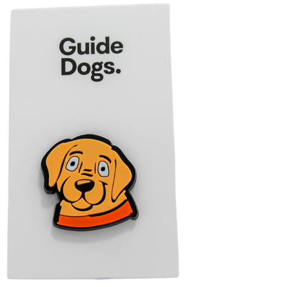 Image of a beige puppy face with orange collar on a white card with text of 'Guide Dogs'.