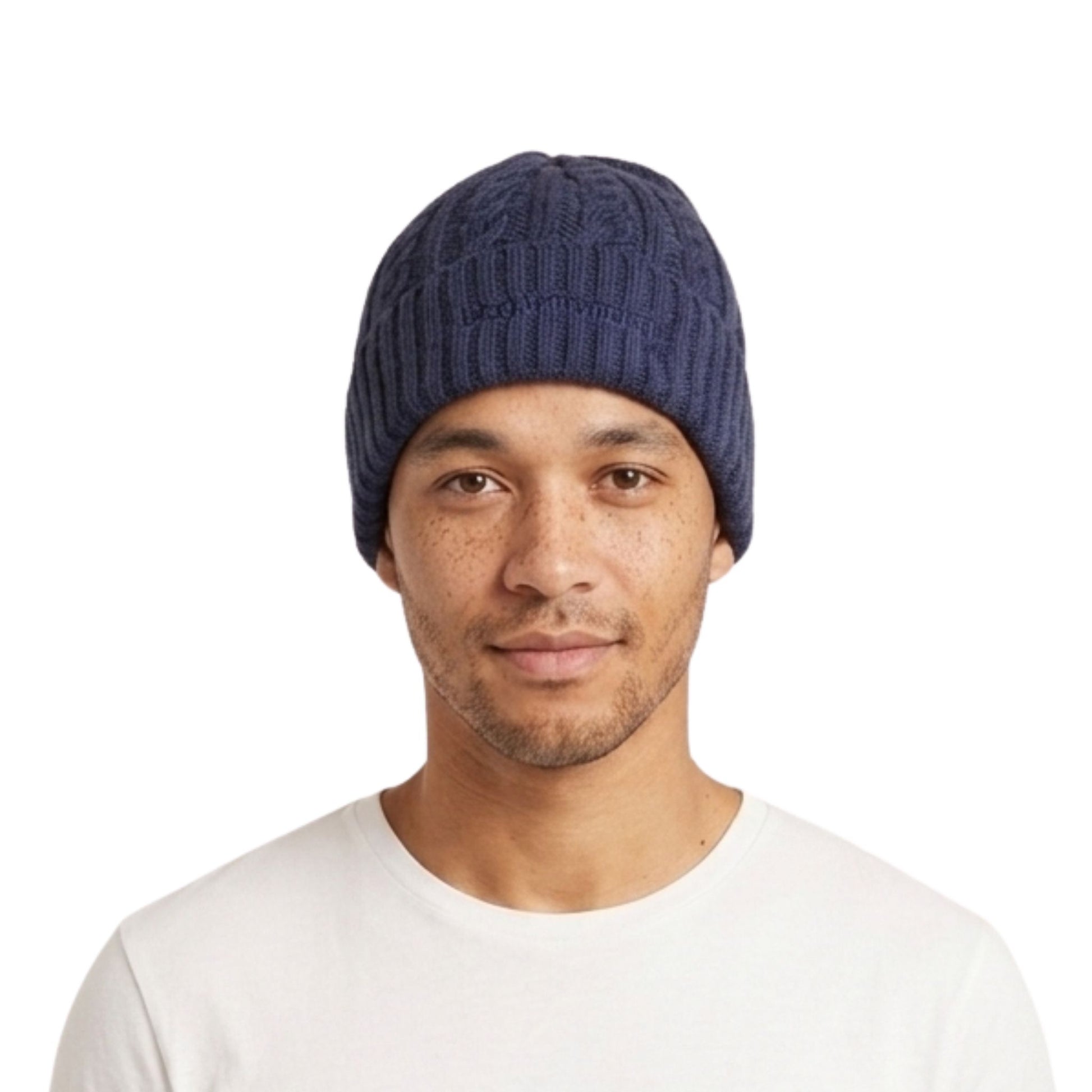 Image of a man wearing a navy blue cable-knit beanie hat and a white t-shirt, photographed against a solid white background.