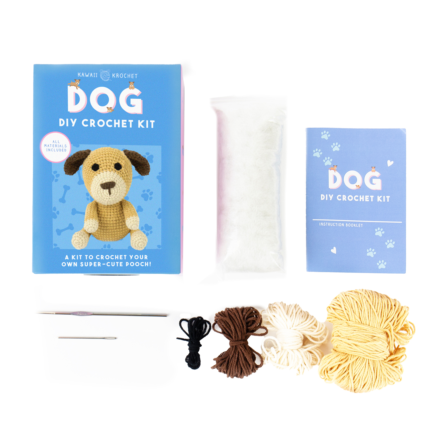 Image of a top-down view of the Crochet Kit for beginners, showing a blue box with a crochet dog image, stuffing, instruction booklet, two crochet needles, black and brown thread, and three yarn skeins in brown, cream, and yellow.