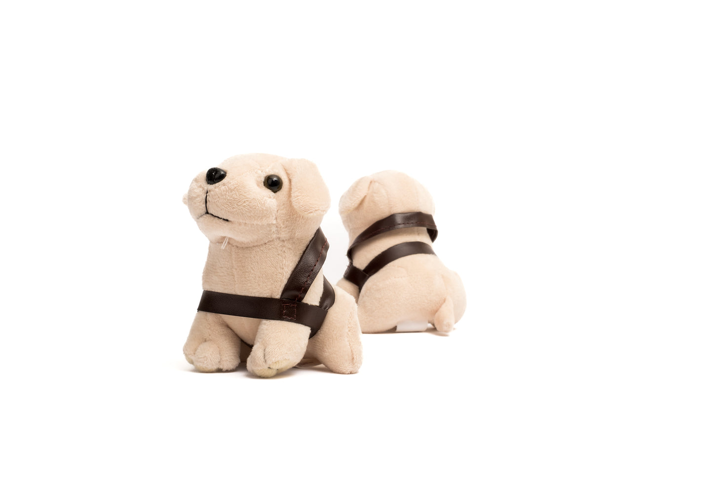 Image of two cream Mini Plush Dogs with brown harnesses, one facing forward, one backwards.