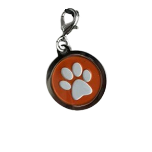 Image of a round metal charm with a white paw print on an orange background.