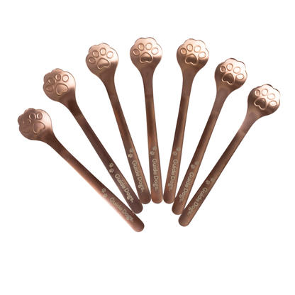 Image of Seven Spoon - Paw Print utensils with cat paw handles fanned out on a white background.