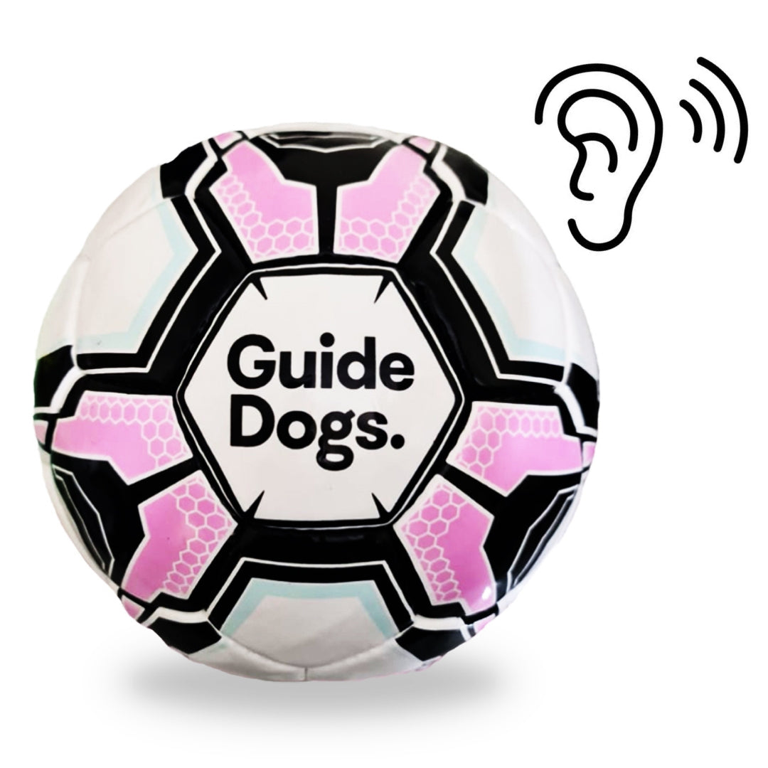 Image of a pink, black and white Soccer Ball with the text "Guide Dogs" and an illustration of an ear.